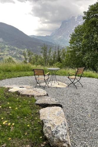 a picnic table and two chairs on a gravel road at Holiday Home Chalet Simeli by Interhome in Grindelwald