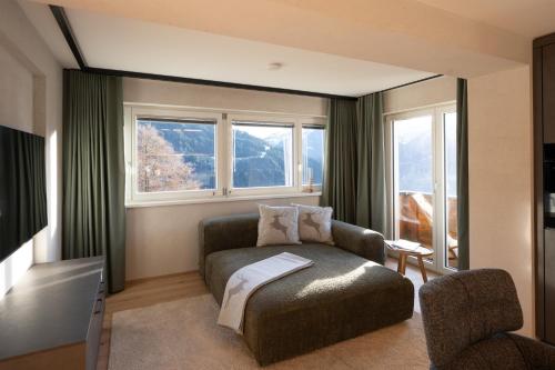 a living room with a couch and a window at Chalet Emely in Bartholomäberg