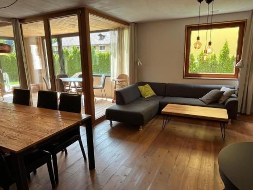 a living room with a couch and a table at Apartment Chasa Ernst by Interhome in Zernez