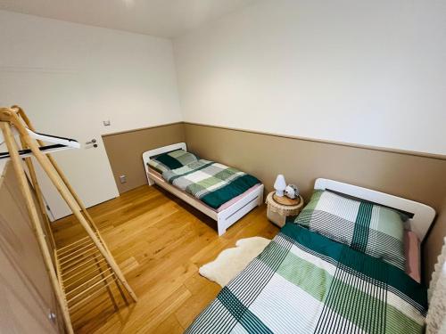 a room with two beds in a room at Ubytování Jitřenka in Černá Voda