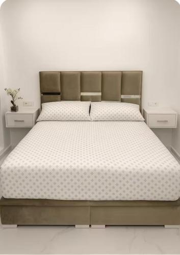 a bed in a room with two nightstands and a bed sidx sidx sidx at Dreamy ocean getaway! Renovated bungalow in M'diq
