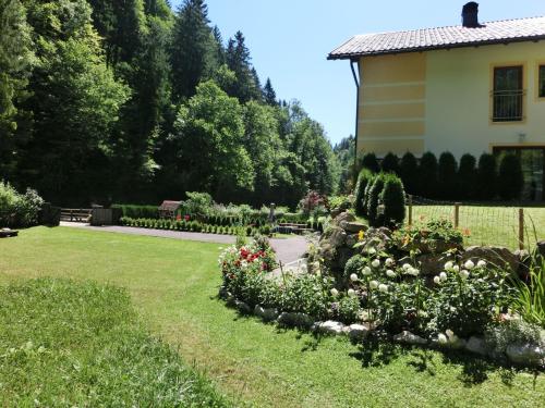a house and a garden with flowers in the yard at Apartment Eulenrast in Loich by Interhome in Loich