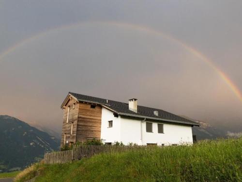 a rainbow over a house on a hill at Apartment Hof Quadra by Interhome in Flerden