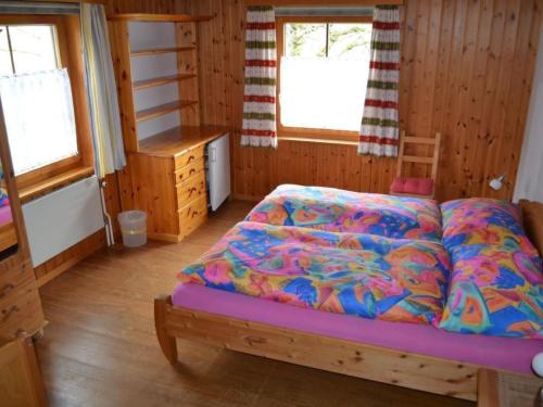 a bedroom with a bed in a wooden room at Apartment Wohnung Bellevue by Interhome in Chevenez
