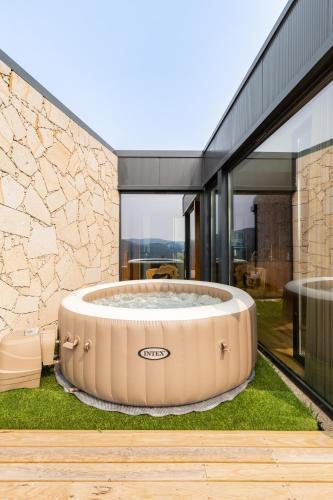 a hot tub in the yard of a house at Casas Bouro 1 Casa Das Hortências in Terras de Bouro