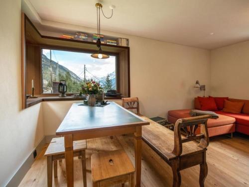 a living room with a table and a couch at Holiday Home Eggwald by Interhome in Wassen