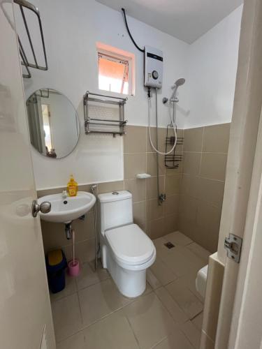 a bathroom with a toilet and a sink at Jorich home stay in Dumaguete