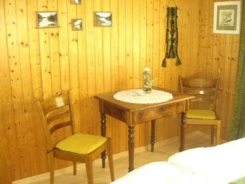 a table and chairs in a room with wooden walls at Apartment Bijou by Interhome in Alt Sankt Johann