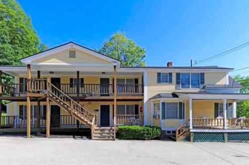 a large house with a staircase in front of it at Dream Weaver in Ludlow