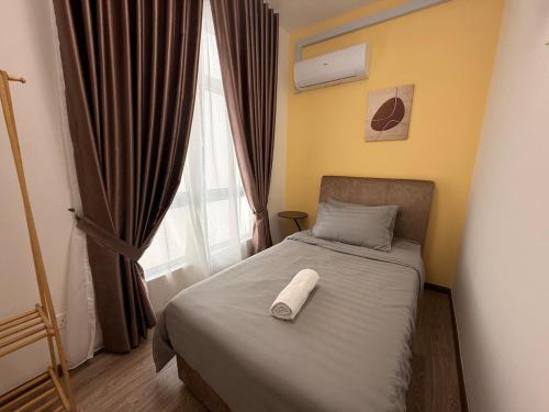 a bedroom with a bed with a towel on it at Self Check in at Classy 3BR Kajang in Kajang