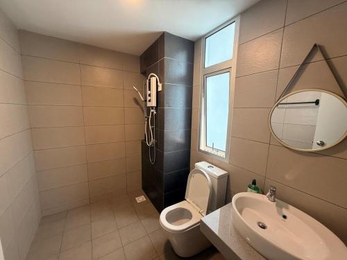 a bathroom with a toilet and a sink and a mirror at Self Check in at Classy 3BR Kajang in Kajang