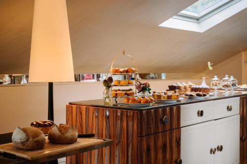 a table with a cake and some pastries on it at Palazzo Venezia in Como
