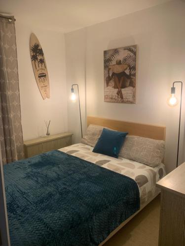 a bedroom with a bed and a surfboard on the wall at T2 Port Frejus proximite de la plage Grand Garage Prive in Fréjus