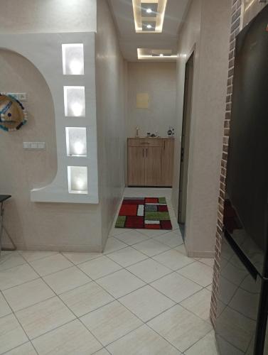 a room with a bathroom with a window and a tile floor at Cozy and Comfortable Apartment in Agadir