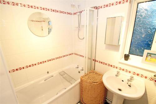 a bathroom with a tub and a sink and a toilet at 1 Bed in Bishopston oc-hh648 in Bishopston