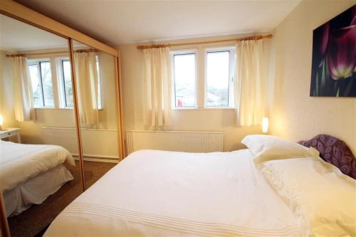 a bedroom with two beds and a mirror at 1 Bed in Bishopston oc-hh648 in Bishopston