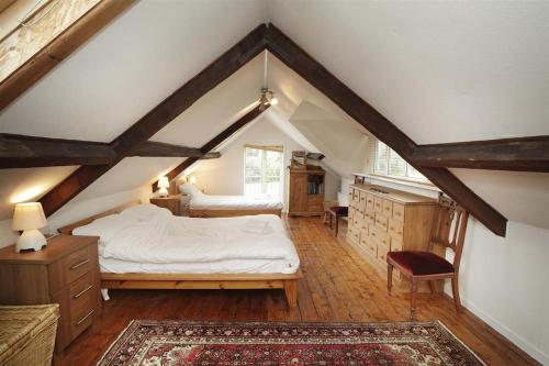 a bedroom with a white bed in a attic at 4 Bed in Penmaen oc-hh86 in Nicholaston