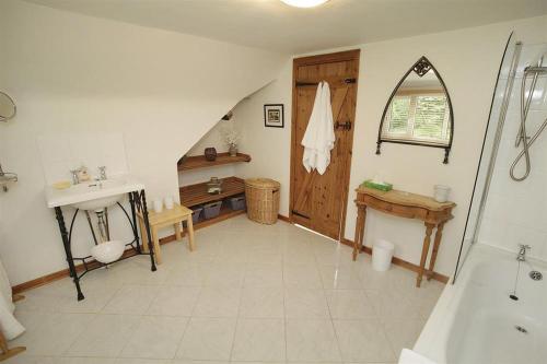 a bathroom with a shower and a sink and a tub at 4 Bed in Penmaen oc-hh86 in Nicholaston