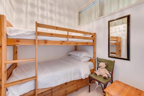 a bedroom with two bunk beds and a teddy bear at 2 Bed in Gower oc-hh919 in Bishopston