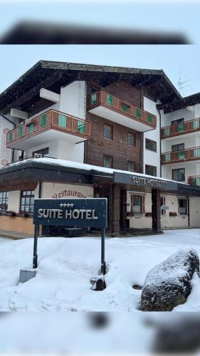 a sign in the snow in front of a hotel at Suitehotel Kleinwalsertal in Hirschegg