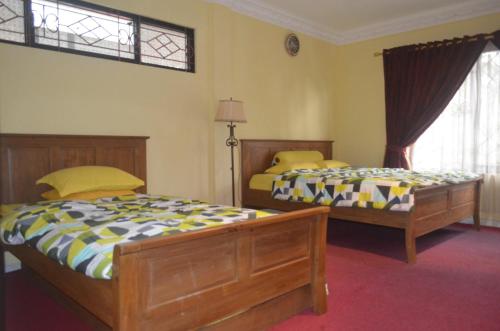 Postel nebo postele na pokoji v ubytování Villa Omah Jamuniro