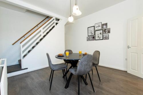 a dining room with a table and chairs at K Suites - Granville Avenue in Long Eaton