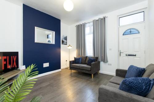 a living room with a couch and a chair at K Suites - Granville Avenue in Long Eaton
