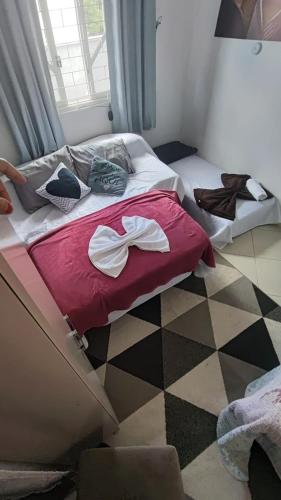 a bedroom with two beds with bows on them at Quarto Prime até 4 pessoas familia, piscina, Pousada Lua Encantada Pousada Tijucas in Tijucas