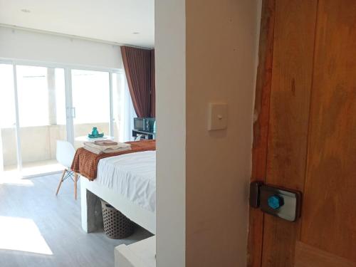 a bedroom with a bed and a table and a window at Inuli Coco Hut in Kalutara