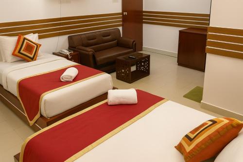 a hotel room with two beds and a chair at Baral Richmart Resthouse in Barisāl