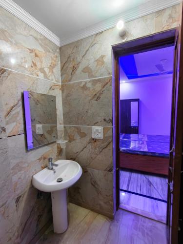 a bathroom with a sink and a walk in shower at Homestay Mohali in Chandigarh Airport