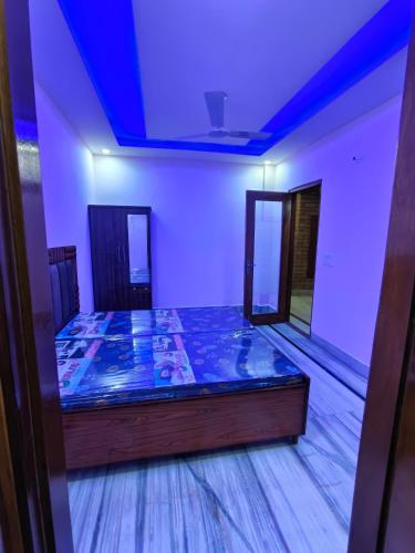 a bed in a room with a blue ceiling at Homestay Mohali in Chandigarh Airport