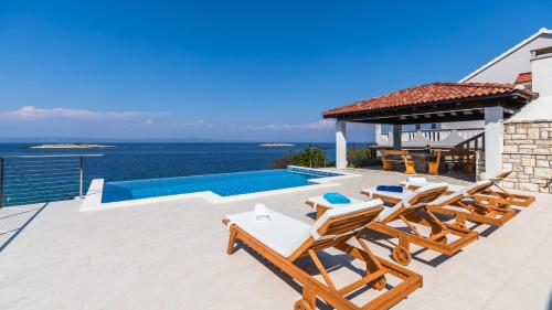 Seafront Villa Mijo by Villas Guide