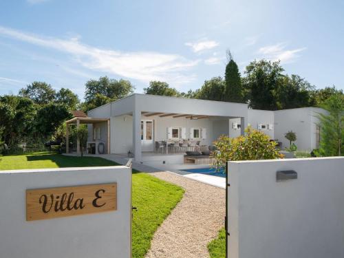 a white house with a sign in front of a yard at Holiday Home mit eigenem Pool by Interhome in Čepljani