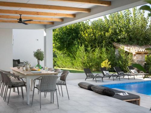 a patio with a table and chairs and a pool at Holiday Home mit eigenem Pool by Interhome in Čepljani