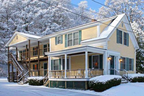 a large house with snow on the ground at Cozy Ludlow Escape in Ludlow