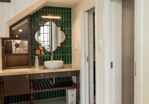 a bathroom with a sink and a mirror at Green Villas Tropical Phú Quốc in Phu Quoc