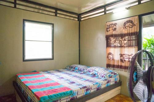 a bedroom with a bed and a window at Weekender Bungalow in Lamai
