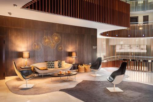 a living room with chairs and a couch at Meliá Sol y Nieve in Sierra Nevada