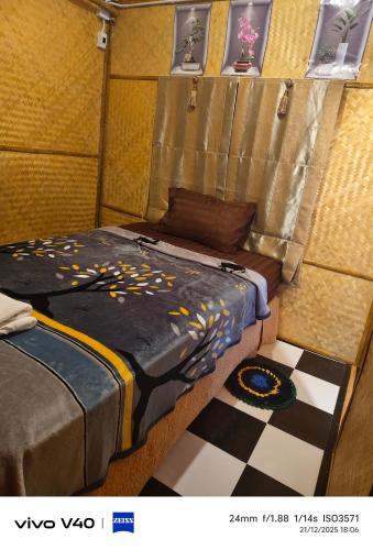 a room with two beds and a checkered floor at Fa eap Bungalow in Ko Lanta Yai