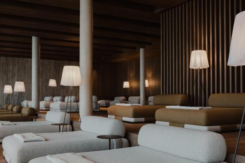 a room with couches and beds and lights at Hotel Oberforsthof in Sankt Johann im Pongau