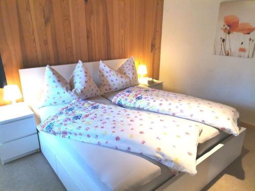 a bedroom with a white bed with polka dot pillows at Apartment Gemütliche FeWo by Interhome in Innertkirchen