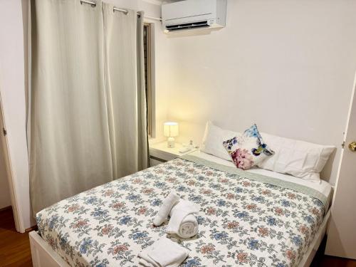 a bedroom with a bed with towels on it at Affordable accommodation near Perth CBD in Perth