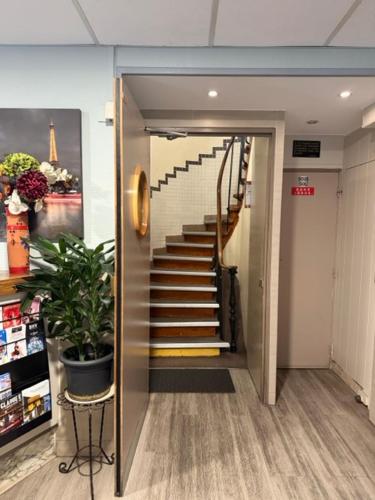 a hallway with a staircase in a building at Hôtel Jarry Confort in Paris