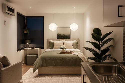 a bedroom with a bed and a sink at Cosy Footscray Studio - 2 Guests in Melbourne
