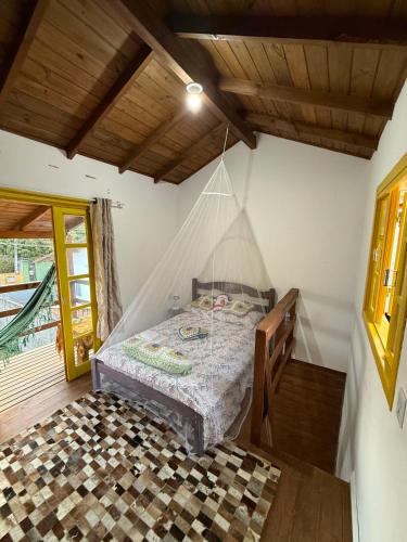 a bedroom with a bed with a net at Casa no Norte da Ilha in Florianópolis