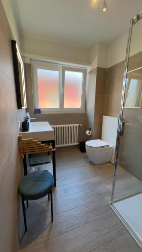 a bathroom with a sink and a tub and a toilet at RELAX Glicine Apartment in Locarno