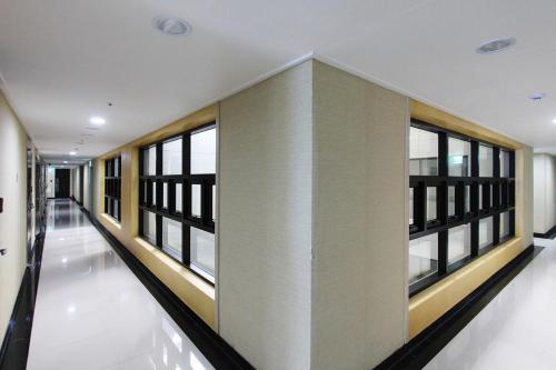 an empty hallway with windows in a building at Intercity Seoul Hotel in Seoul