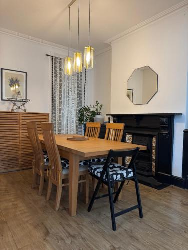 a dining room with a wooden table and chairs at Large Home Sleeps 6 Central Location Free Parking in Plymouth