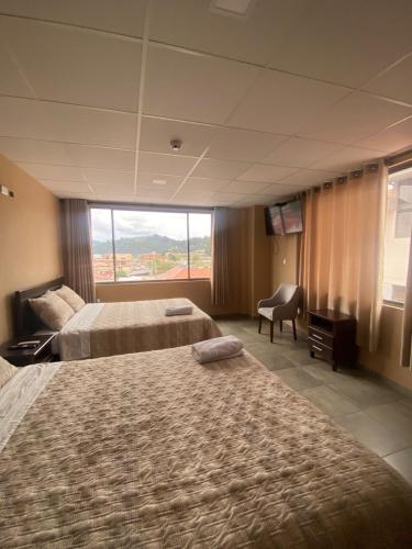 En eller flere senge i et værelse på Stelar Hostal